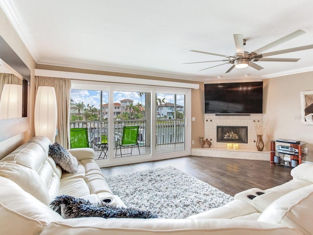 living room with hardwood / wood-style floors, a healthy amount of sunlight, and crown molding