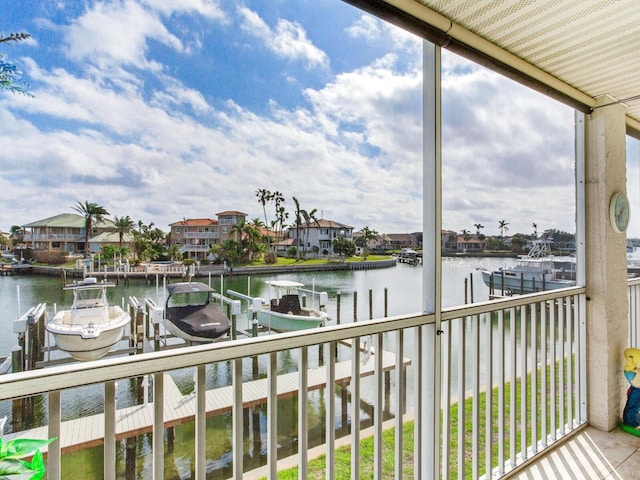 sunroom featuring a water view