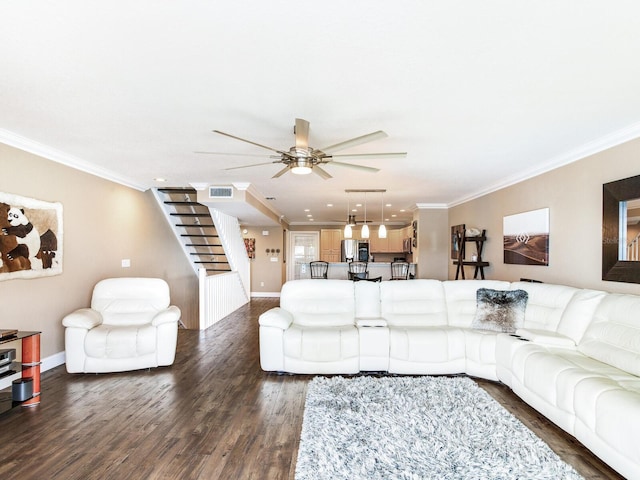 living room with dark hardwood / wood-style flooring, ceiling fan, and ornamental molding