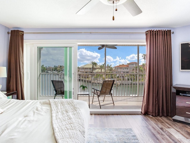 bedroom featuring access to exterior, wood-type flooring, and ceiling fan