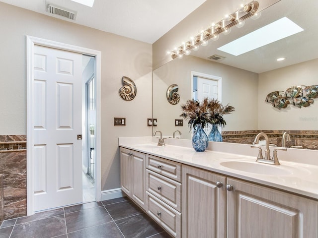 bathroom featuring vanity and a skylight