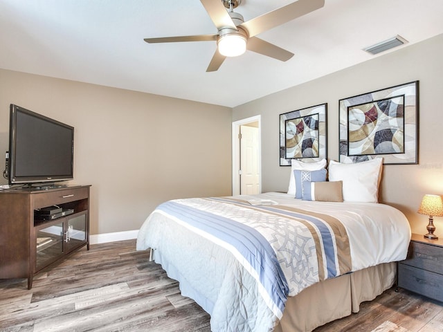 bedroom with hardwood / wood-style flooring and ceiling fan