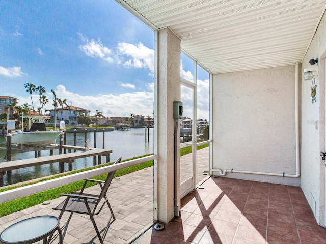 balcony featuring a water view and a boat dock