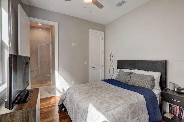 bedroom with ceiling fan, dark hardwood / wood-style flooring, and ensuite bath