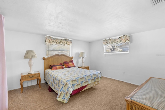 carpeted bedroom featuring a textured ceiling