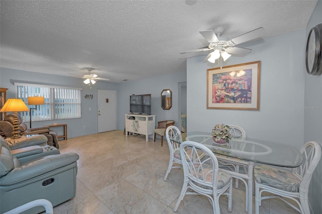 dining room with a textured ceiling and ceiling fan