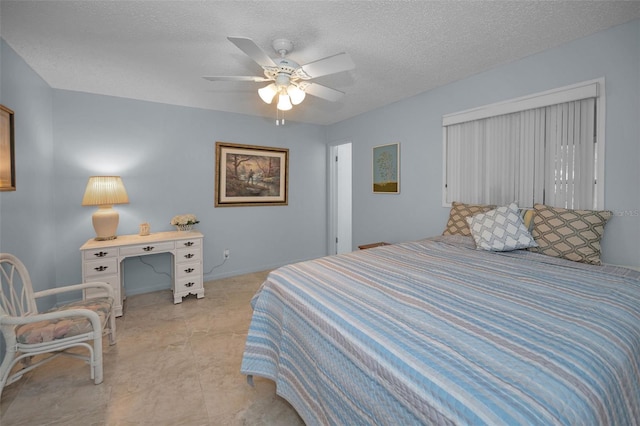 bedroom with ceiling fan and a textured ceiling