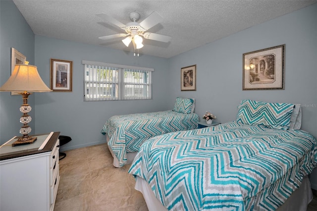 bedroom featuring ceiling fan and a textured ceiling