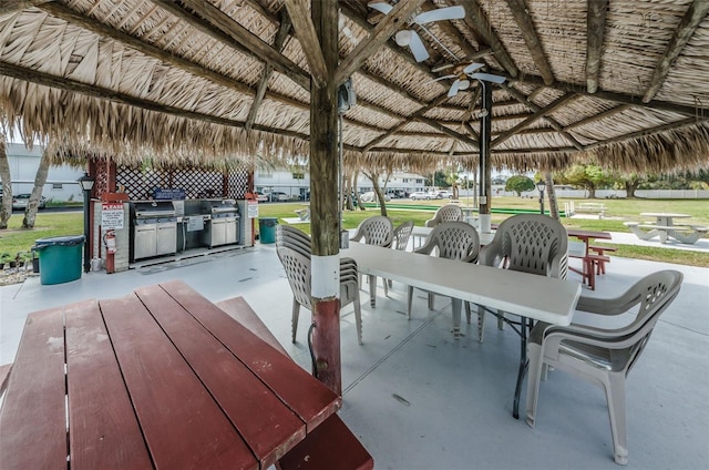 view of patio featuring exterior kitchen, a gazebo, and ceiling fan