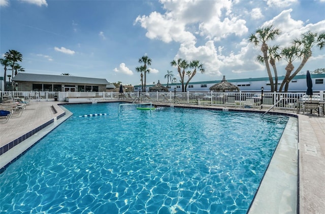 pool with fence and a patio