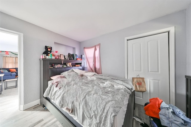 bedroom with a closet and light wood-type flooring