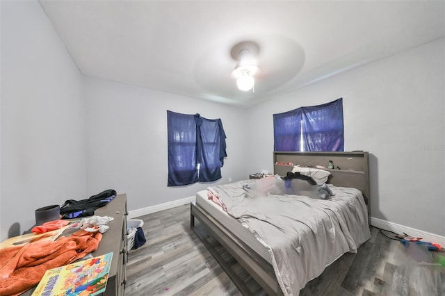 bedroom featuring hardwood / wood-style flooring and ceiling fan