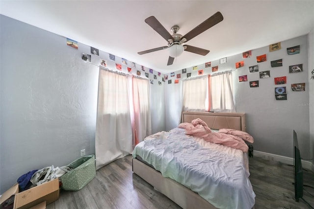 bedroom featuring ceiling fan and dark hardwood / wood-style floors