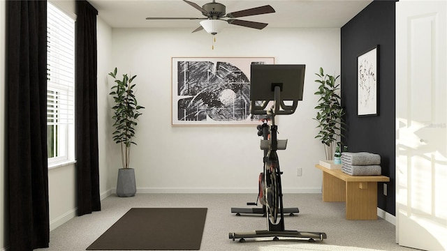 exercise area with light carpet and ceiling fan