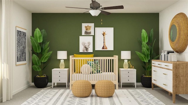 bedroom with carpet flooring, ceiling fan, and a crib