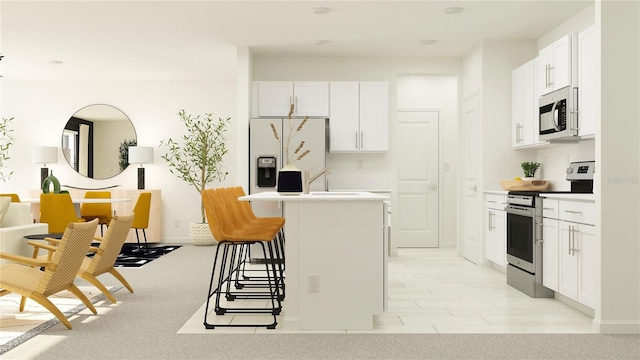 kitchen with a center island, white cabinets, a breakfast bar area, light colored carpet, and stainless steel appliances