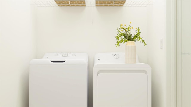 clothes washing area featuring washer and dryer