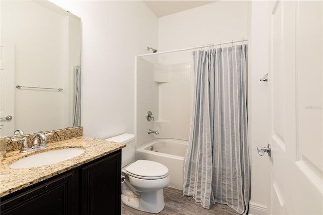 full bathroom with vanity, hardwood / wood-style flooring, toilet, and shower / bath combo with shower curtain