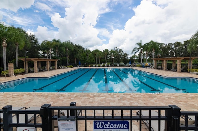 view of swimming pool with a pergola and a patio