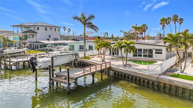 dock area with a water view and a patio