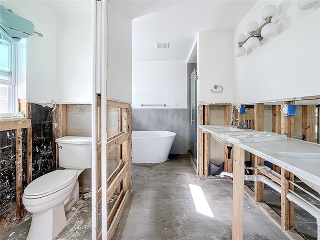 bathroom with a bath and toilet