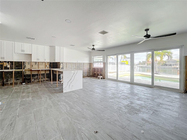 interior space featuring ceiling fan and sink