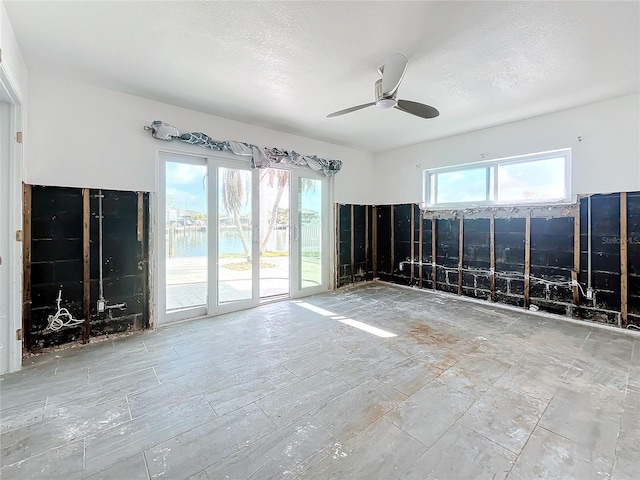 spare room featuring ceiling fan and a textured ceiling