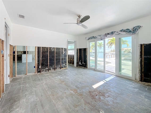 unfurnished living room featuring ceiling fan