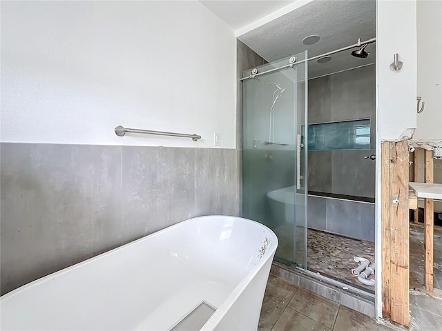 bathroom with tile patterned floors and plus walk in shower