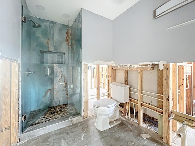 bathroom with toilet and a shower with door