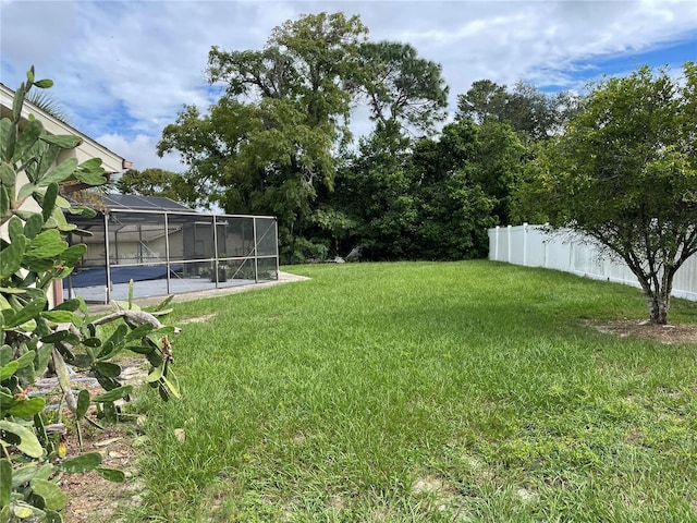 view of yard featuring glass enclosure