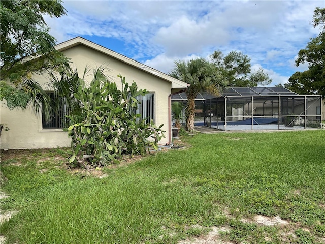 view of yard featuring a lanai and a swimming pool