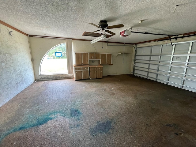 garage featuring ceiling fan and a garage door opener