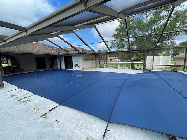 view of pool with glass enclosure