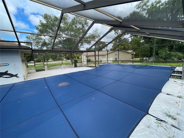 view of pool with glass enclosure