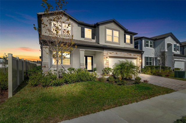 view of front of house featuring a yard and a garage