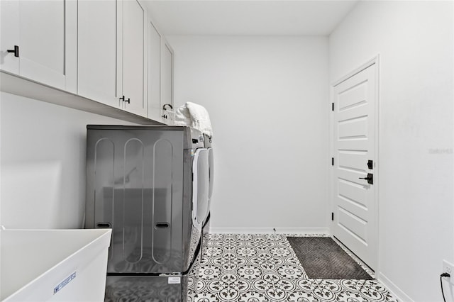 laundry area featuring cabinets and washing machine and clothes dryer