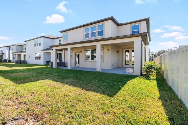 back of house featuring a yard, a patio area, french doors, and central AC unit