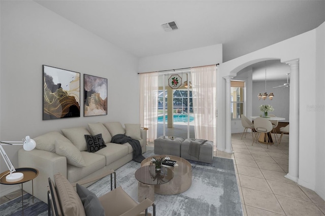 tiled living room with ornate columns and ceiling fan