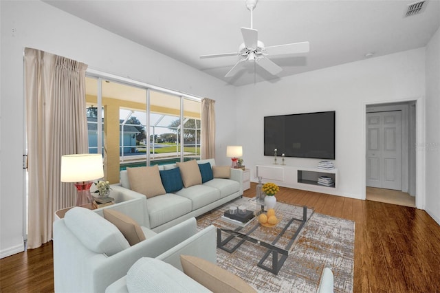 living room with dark hardwood / wood-style floors and ceiling fan