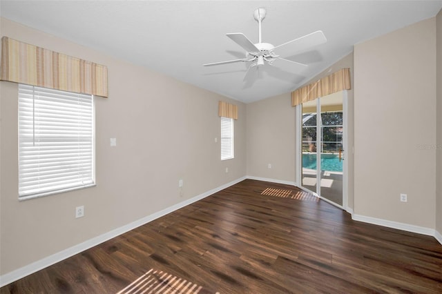 spare room with dark hardwood / wood-style floors and ceiling fan