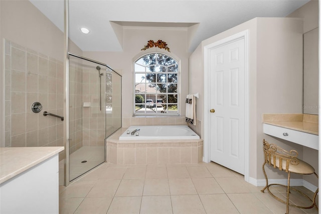 bathroom featuring plus walk in shower, vanity, and tile patterned floors