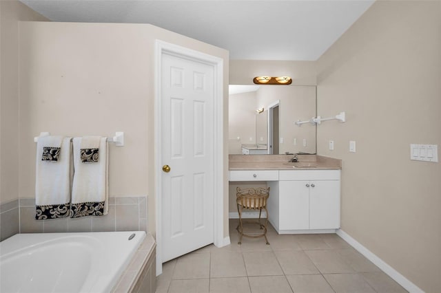 bathroom featuring tile patterned flooring, vanity, and a relaxing tiled tub