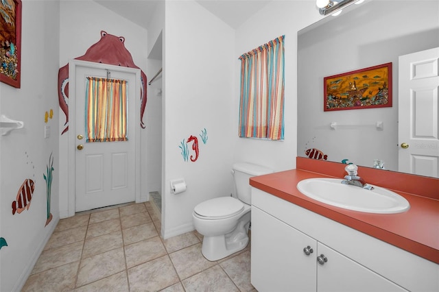 bathroom with tile patterned flooring, vanity, toilet, and a shower