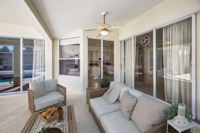 sunroom / solarium with ceiling fan and vaulted ceiling