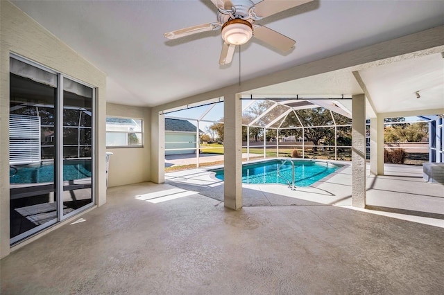 view of swimming pool featuring a patio, ceiling fan, and a lanai