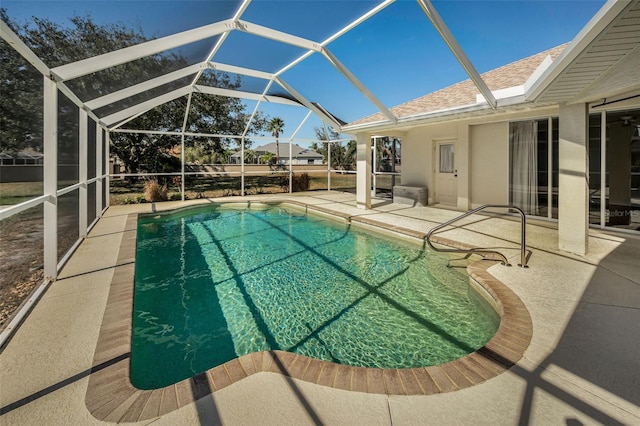 view of swimming pool with a patio and a lanai