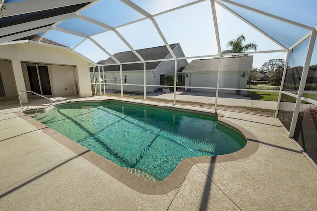 view of pool with a lanai and a patio