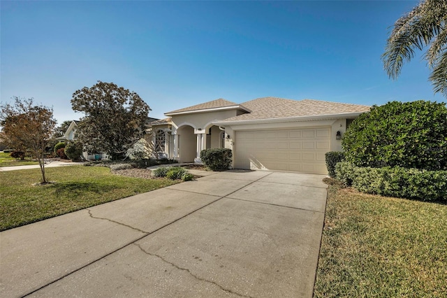 view of front of property featuring a garage and a front yard