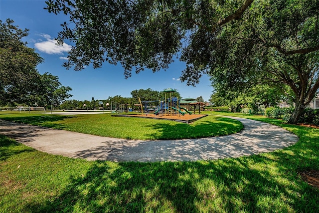 view of home's community with a lawn and a playground